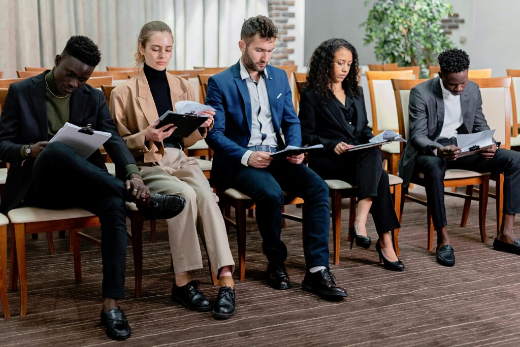 A diverse group of business professionals reviewing documents in a meeting setting.