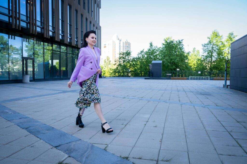 pexels-photo-9476296-9476296 Confident woman in a purple blazer walking with a prosthetic leg outdoors. Embracing elegance and empowerment.
